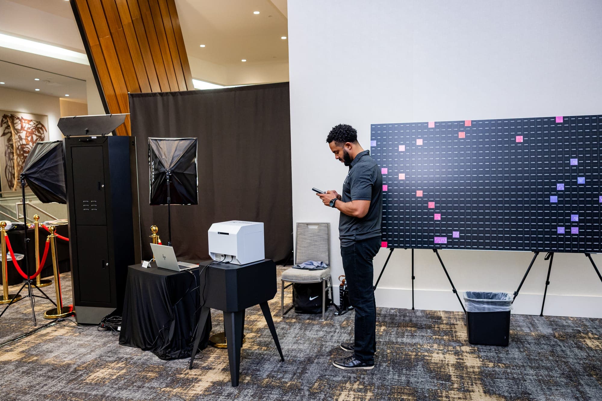 A wide view of the booth, the printer station and the mosaic wall in the event space