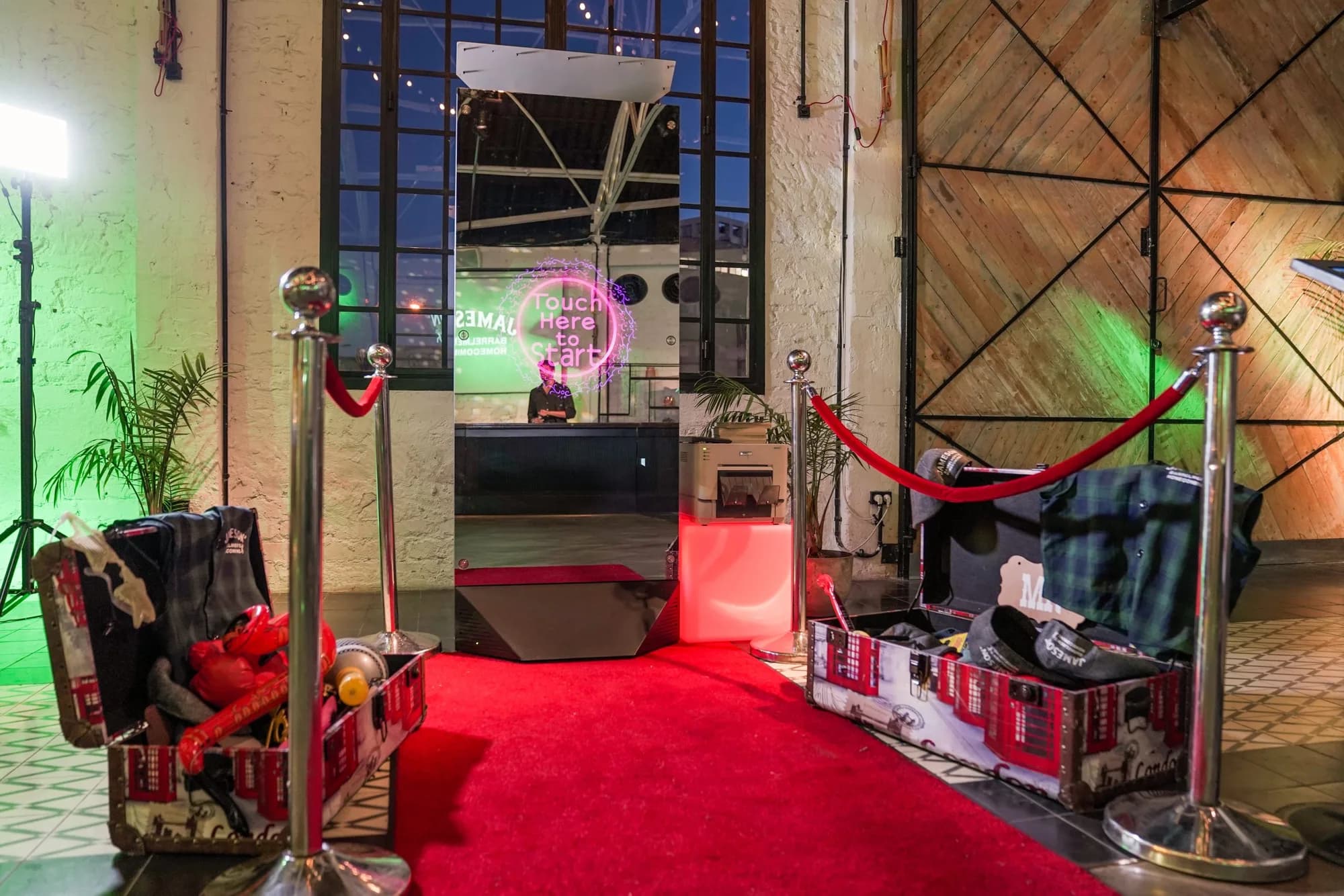 A Mirror X booth set up on a red carpet in a venue